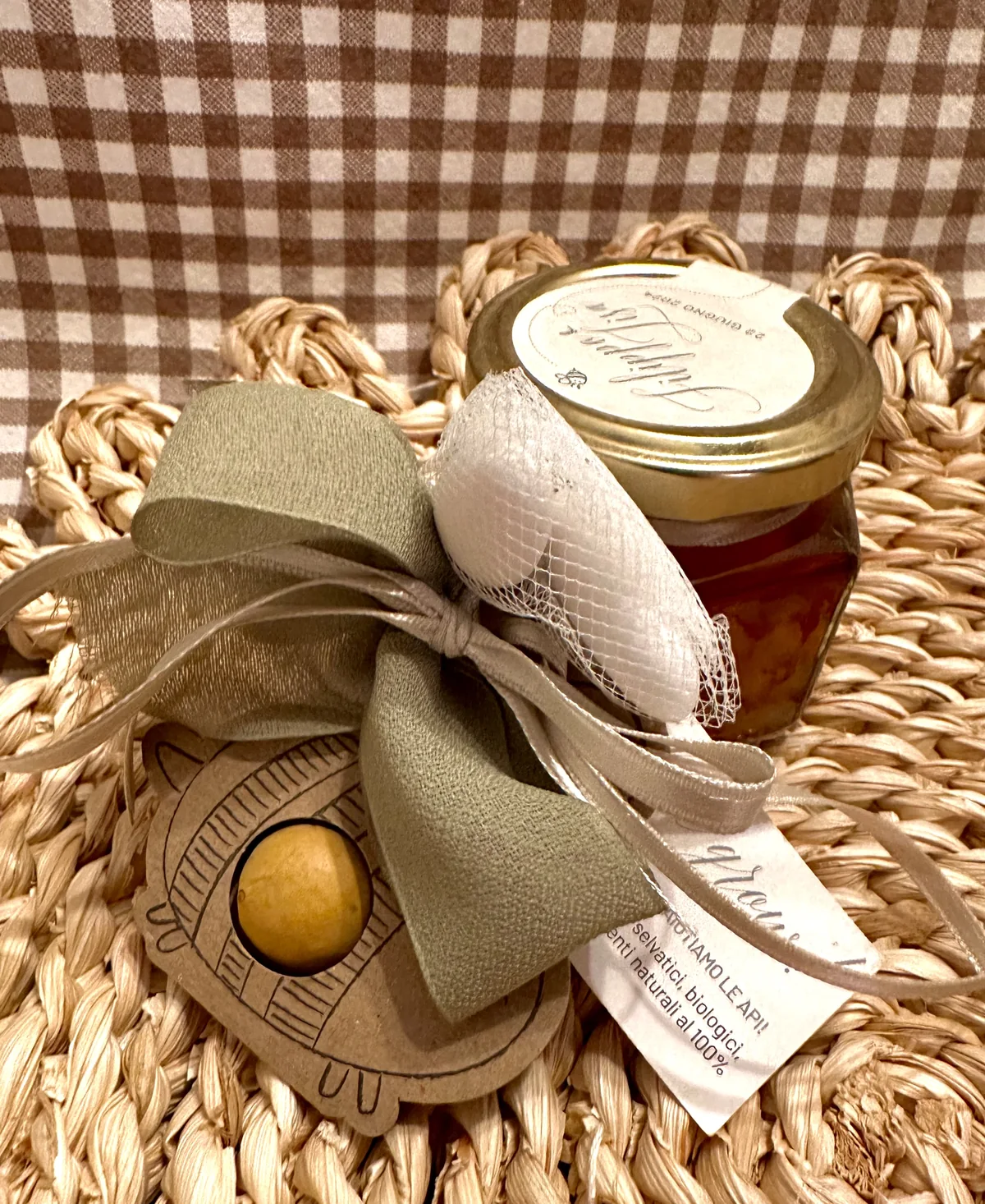 Favour with a jar of honey, sugared almonds and a sage-green bow